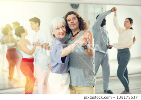 Elderly woman enjoying dancing in pair with expressive man Elderly woman enjoying dancing in pair with expressive man 138175637