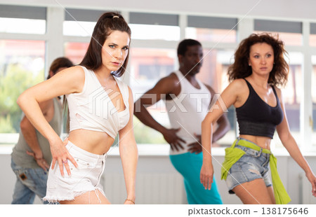 Female instructor performing expressive sass dance at group class 138175646