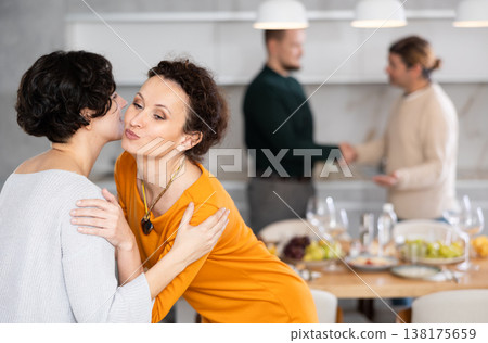 After chatting and gatherings, women friends hug and kiss goodbye. After chatting and gatherings, women friends hug and kiss goodbye. 138175659