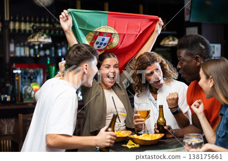 Fans with the flag of Portugal celebrate the victory of their favorite team in beer bar 138175661