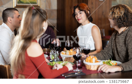 Family having dinner and talking in restaurant Family having dinner and talking in restaurant 138175667