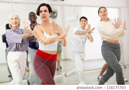 Happy Latina enjoying active dancing during group training 138175703