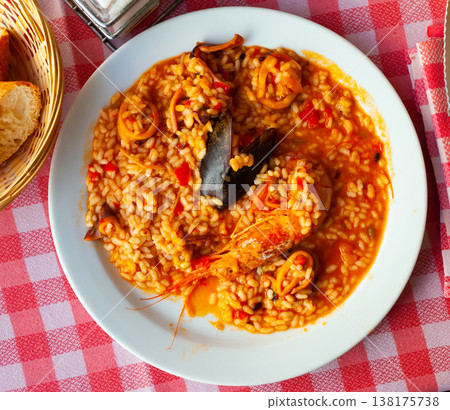Delicious traditional Valencian seafood paella - savory rice dish with shrimps and clams Delicious traditional Valencian seafood paella - savory rice dish with shrimps and clams 138175738