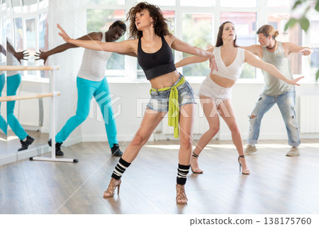 Fit woman performing sensual high heels choreography at group class Fit woman performing sensual high heels choreography at group class 138175760