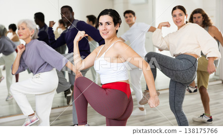 Young Hispanic woman practicing vigorous dance movements Young Hispanic woman practicing vigorous dance movements 138175766