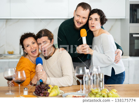 Group of friends are having fun singing karaoke during feast and gatherings. Group of friends are having fun singing karaoke during feast and gatherings. 138175774