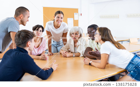 Young girl participating in Spanish language speaking club with group of people of different ages Young girl participating in Spanish language speaking club with group of people of different ages 138175828