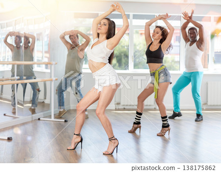 Female instructor performing expressive sass dance at group class Female instructor performing expressive sass dance at group class 138175862