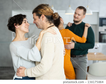 Men and women dancing during house party. Men and women dancing during house party. 138175864