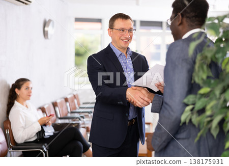 Two adult man shaking hands in reception Two adult man shaking hands in reception 138175931