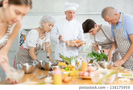 Professional personal chef cook in customer private kitchen house giving cooking lesson to people at home 138175959