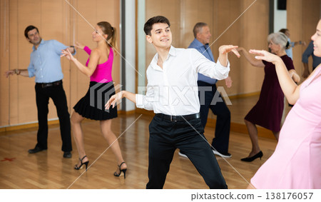 Guy enjoying dancing playful twist with female partner 138176057