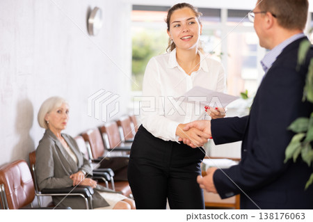 Adult man and young woman make an agreement Adult man and young woman make an agreement 138176063