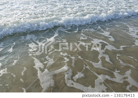 Waves crashing onto the sandy beach in winter Waves crashing onto the sandy beach in winter 138176413