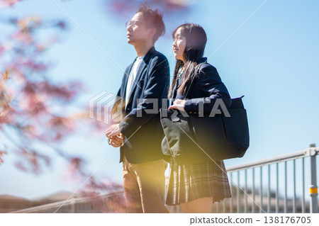 Adults and students gazing at the future under the cherry blossoms Adults and students gazing at the future under the cherry blossoms 138176705