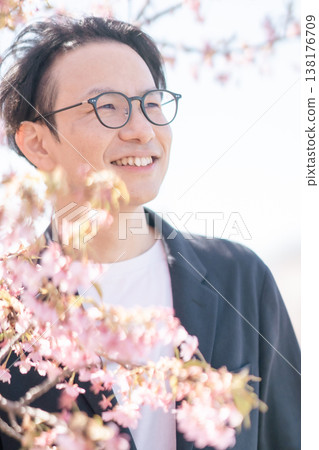 A businessman refreshed after a successful career change, bathed in the spring sunshine. A businessman refreshed after a successful career change, bathed in the spring sunshine. 138176709
