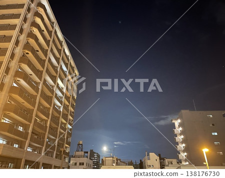 A night view of a residential area and apartment buildings as the full moon rises. A night view of a residential area and apartment buildings as the full moon rises. 138176730