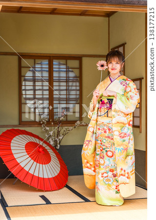 A young Japanese woman wearing a furisode kimono in a Japanese-style room (coming-of-age ceremony, 20th birthday celebration) A young Japanese woman wearing a furisode kimono in a Japanese-style room (coming-of-age ceremony, 20th birthday celebration) 138177215