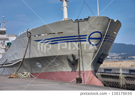 Bow of an industrial fishing vessel docked at the Vigo port pier under a clear sky Bow of an industrial fishing vessel docked at the Vigo port pier under a clear sky 138178030