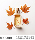 Glass jar with amber liquid and cork stopper on white background with fall leaves 138178143