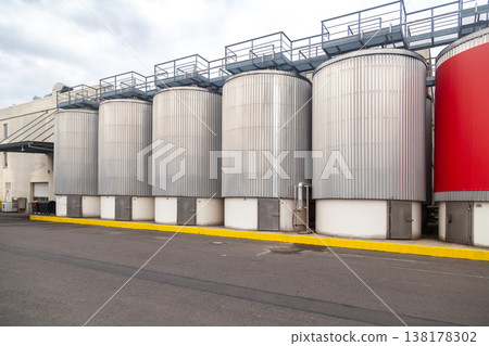 large industrial fermentation tanks at brewery 138178302