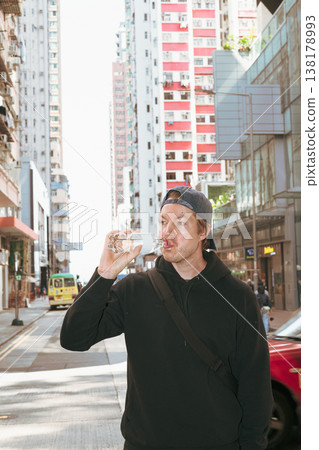 Scandinavian Man Drinking Water in Hong Kong City Street 138178993