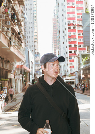 Caucasian Man Holding Bottle on Hong Kong City Street Caucasian Man Holding Bottle on Hong Kong City Street 138178994