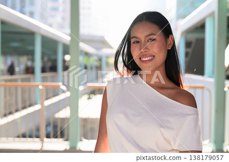 Young Thai Woman Smiling on Hong Kong Elevated Walkway Young Thai Woman Smiling on Hong Kong Elevated Walkway 138179057