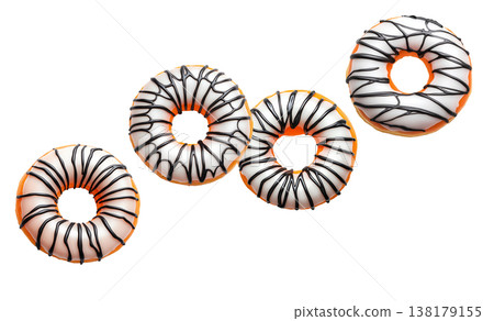 Multiple round glazed donuts with white icing and chocolate drizzle isolated on white background, concept of sweet dessert concept Multiple round glazed donuts with white icing and chocolate drizzle isolated on white background, concept of sweet dessert concept 138179155