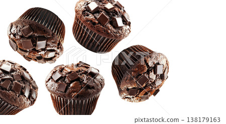 Multiple chocolate chip muffins scattered and isolated on white background, representing sweet dessert concept Multiple chocolate chip muffins scattered and isolated on white background, representing sweet dessert concept 138179163