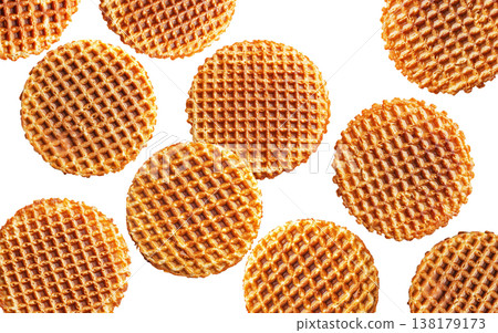 Multiple round caramel stroopwafels arranged in a scattered pattern from above, on a white background. Concept of sweet snacks 138179173