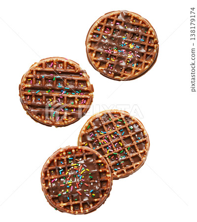 Delicious chocolate syrup covered waffles with colorful sprinkles isolated on white background. Concept of sweet dessert pattern Delicious chocolate syrup covered waffles with colorful sprinkles isolated on white background. Concept of sweet dessert pattern 138179174
