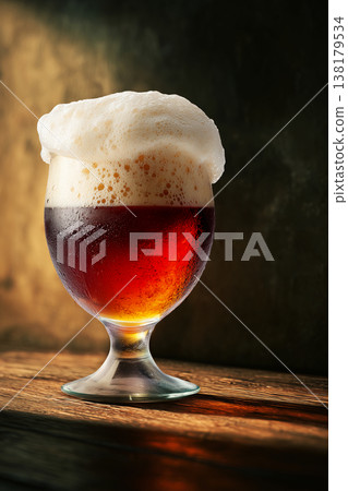 Frothy ruby beer mug with sun lights on warm brown backdrop scene illustrating refreshment concept Frothy ruby beer mug with sun lights on warm brown backdrop scene illustrating refreshment concept 138179534