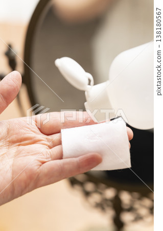 A woman's hands applying makeup. A woman's hands applying makeup. 138180567