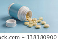 Close-up, soft light, 3D render of a white pill bottle with removed cap and spilled tablets on a pastel blue surface, realistic soft reflections, clean medical aesthetic, the camera is stationary. 138180900