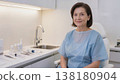 Medium shot, soft lighting, a middle-aged woman undergoing cosmetic procedure in a sterile environment,scincare concept 138180904