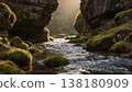 A river flows through a moss-covered canyon, sunlight filtering through narrow rock formations to create dynamic shadows on the water surface, maintaining shallow depth of field. 138180909