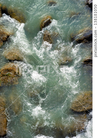 Mountain river flow between rocks top view macro texture 138181050
