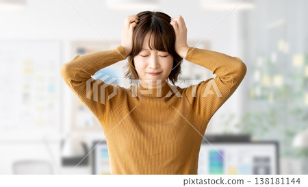 A woman/businesswoman holding her head in trouble A woman/businesswoman holding her head in trouble 138181144