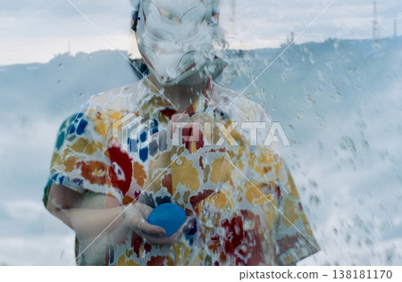 Multiple exposure of a person in a fox mask making water burst in their hand. Multiple exposure of a person in a fox mask making water burst in their hand. 138181170