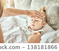 Parent, hands and thermometer with sick kid, fever or flu virus in bed from cold at home. Closeup of mother checking child with illness for temperature or measurement in bedroom or rest at house 138181866