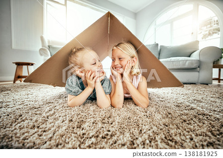 Smile, kids and cardboard for insurance with girl sisters on the floor of the living room at home. Security. family or children and young siblings on a carpet in their house for safety with flare 138181925