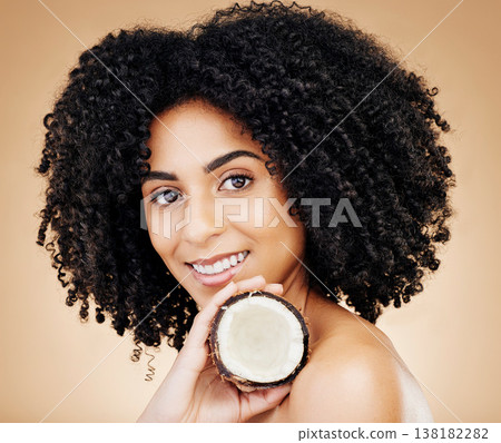 Woman, portrait and hair, coconut with shine and beauty, organic salon treatment for strong texture on studio background. Face, skin and natural cosmetic product for growth with haircare and fruit 138182282