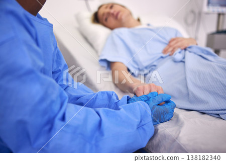 Woman, hospital bed or patient with hand holding, medical and health issue with doctor, sick or virus for support, care and help. Conversation, diagnosis and medicine with healthcare, scared or trust 138182340