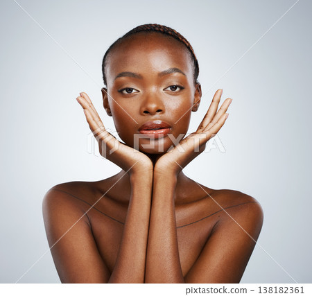 Portrait, skin and hands of a black woman in studio on a gray background for skincare, beauty or natural wellness. Face, spa or luxury and a young model with cosmetic or antiaging aesthetic treatment Portrait, skin and hands of a black woman in studio on a gray background for skincare, beauty or natural wellness. Face, spa or luxury and a young model with cosmetic or antiaging aesthetic treatment 138182361