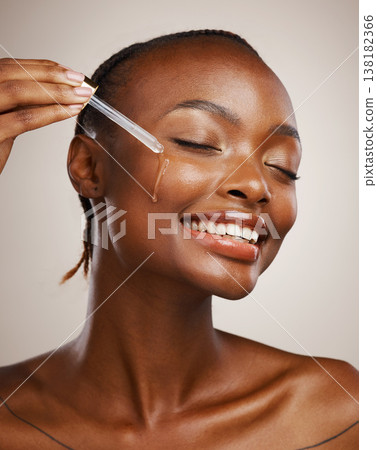 Skincare, woman and smile with dropper on studio background for wellness in cosmetics, beauty or serum. African, person or model by happy, face or relaxed for facial treatment for anti aging oil Skincare, woman and smile with dropper on studio background for wellness in cosmetics, beauty or serum. African, person or model by happy, face or relaxed for facial treatment for anti aging oil 138182366