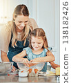 Mom, girl child and eggs in kitchen, development and skills with bonding, love or care in family house. Cooking, mother and daughter with smile, teaching and education by table, bowl or help for food 138182426