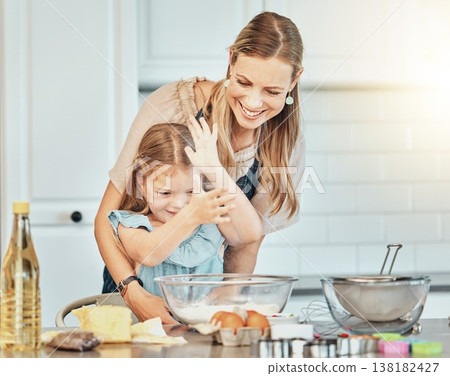Mom, girl child and flour in kitchen, development and baking with bonding, love and care in family house. Cooking, mother and daughter with smile, teaching and eggs on table, dust and help for food 138182427