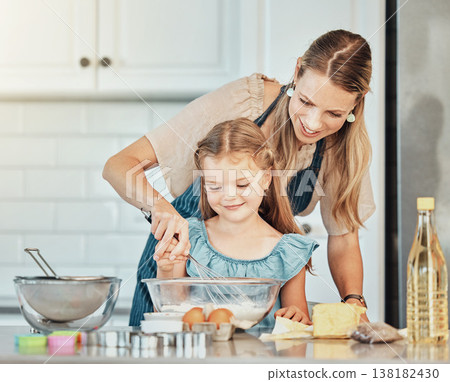 Mom, girl child and learning with whisk, development and skills with bonding, love or care in family house. Cooking, mother and daughter with smile, flour and eggs on table, kitchen and help for food 138182430