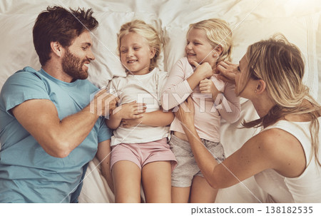 Family, children and parents in bed with smile, happiness and playing. Morning, tickle and funny with mom, dad and girls in bedroom, home and bonding together in top view, playful and affectionate Family, children and parents in bed with smile, happiness and playing. Morning, tickle and funny with mom, dad and girls in bedroom, home and bonding together in top view, playful and affectionate 138182535